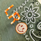 Let's personalize! Green bandana with initials and smiley in orange and beige